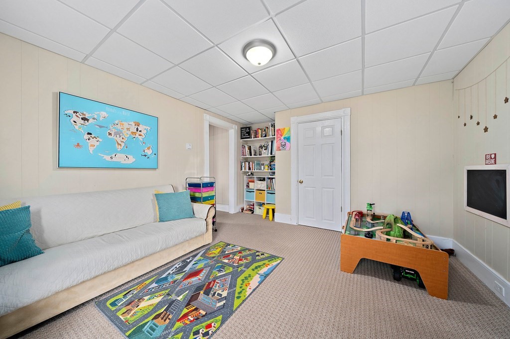 273 Wareham Street Middleboro, MA 02346 - Photo 29 of 42 a living room with furniture and a bookshelf