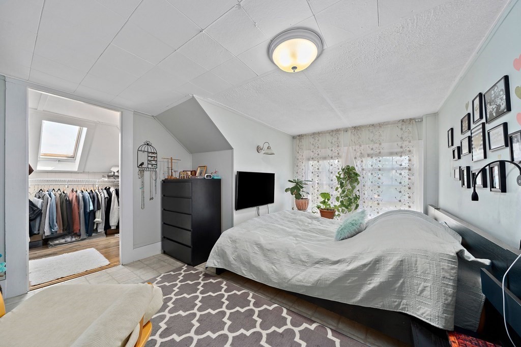 273 Wareham Street Middleboro, MA 02346 - Photo 33 of 42 a bedroom with a bed and a chandelier