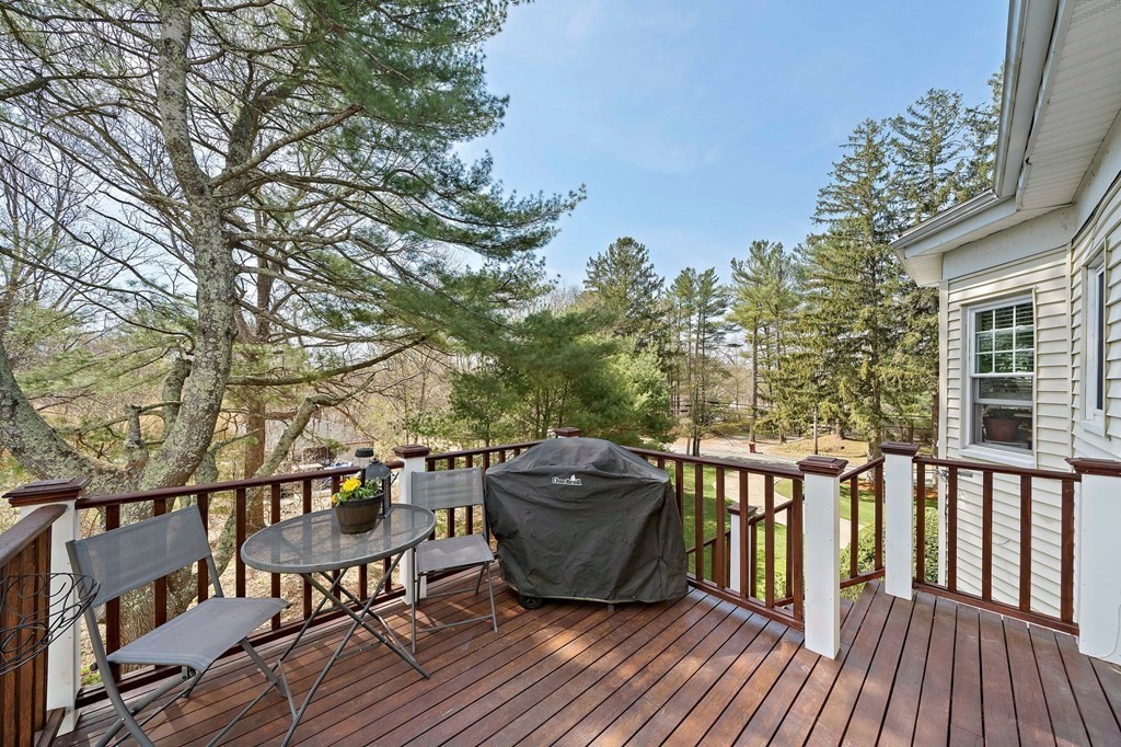 273 Wareham Street Middleboro, MA 02346 - Photo 37 of 42 a view of a roof deck with table and chairs and wooden floor
