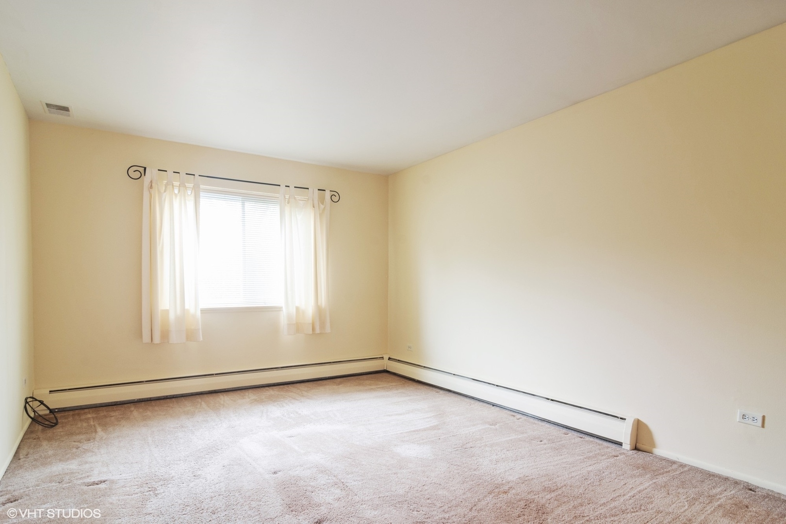 2407 East Brandenberry Court, Unit 1L Arlington Heights, IL 60004 - Photo 6 of 10 an empty room with a empty space and window