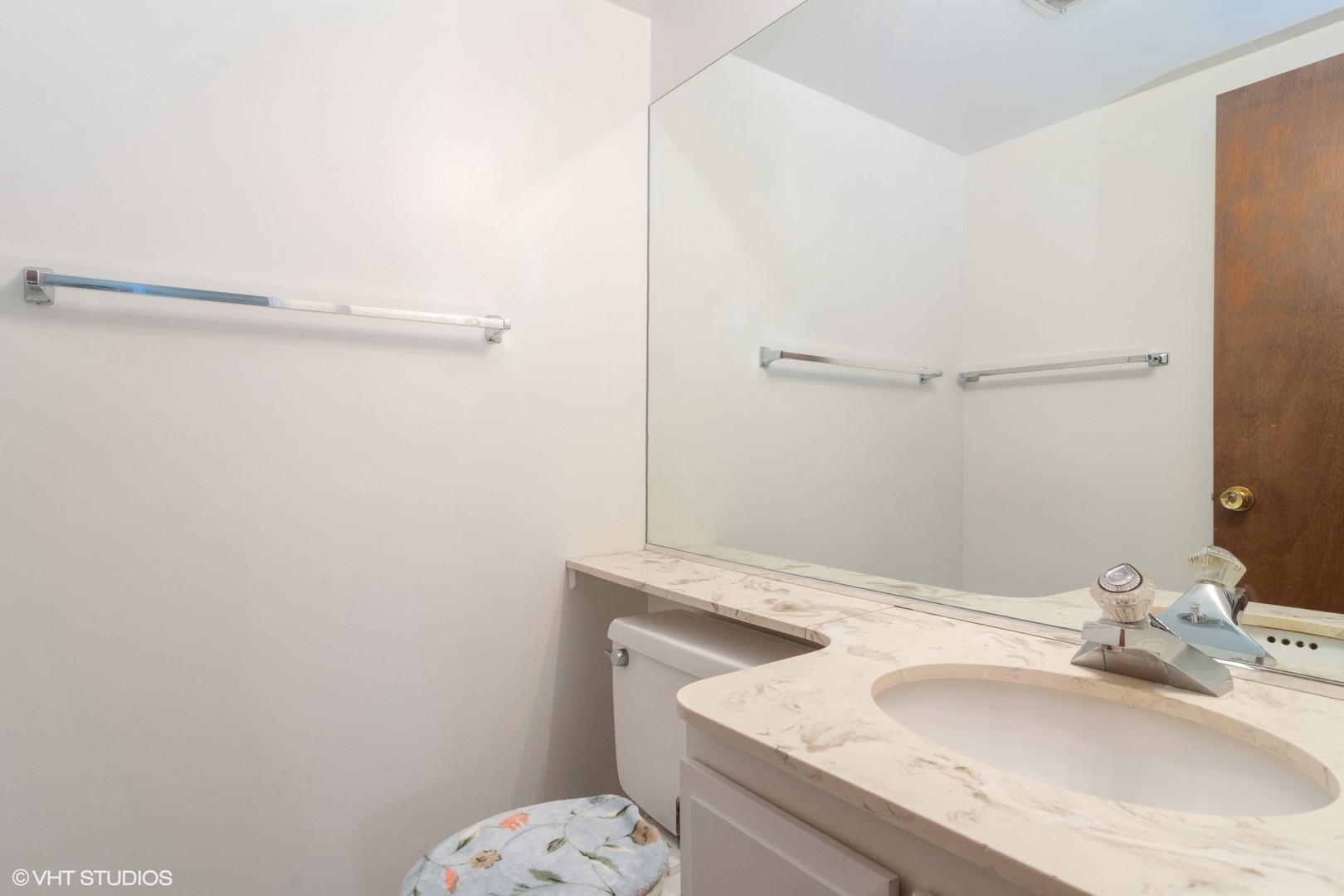 2407 East Brandenberry Court, Unit 1L Arlington Heights, IL 60004 - Photo 7 of 10 a bathroom with a sink and a mirror