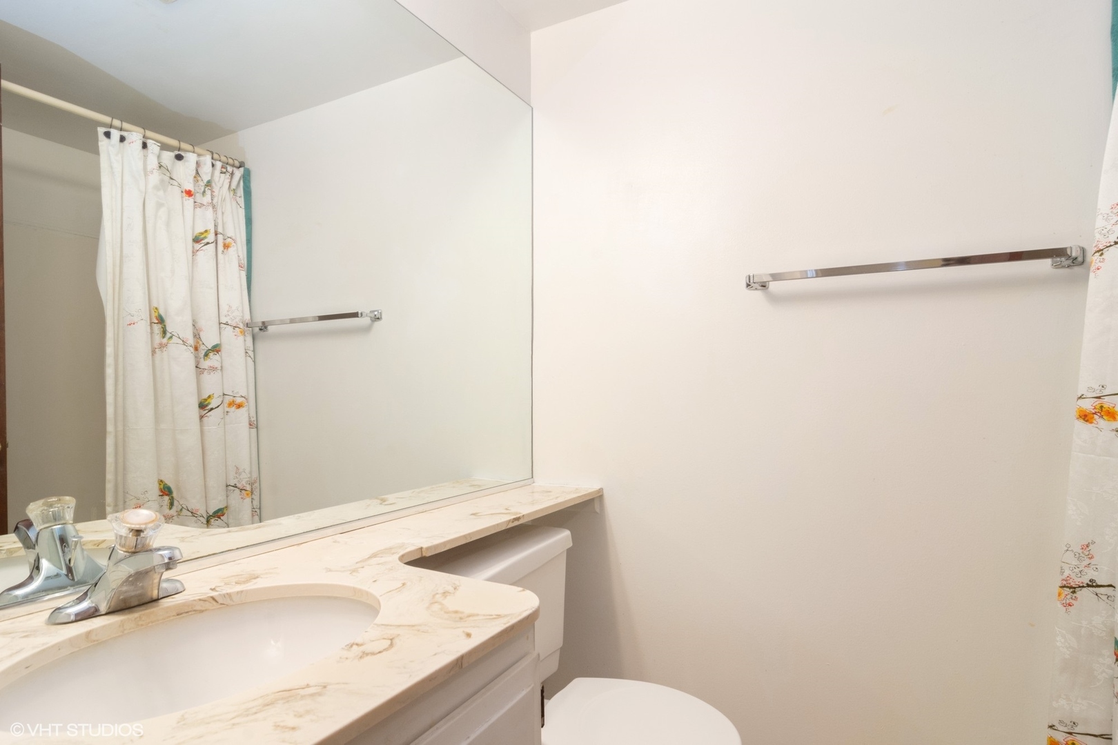 2407 East Brandenberry Court, Unit 1L Arlington Heights, IL 60004 - Photo 10 of 10 a bathroom with a granite countertop sink mirror vanity and toilet