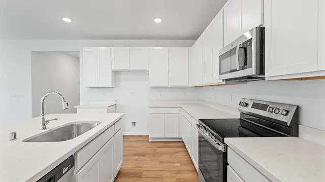 a kitchen that has a sink and a stove