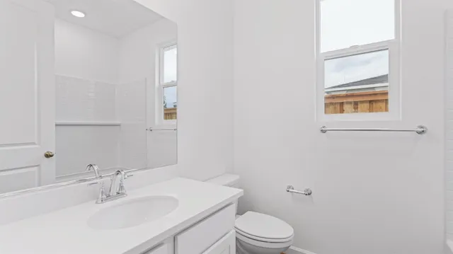 a bathroom with a sink a toilet and a mirror