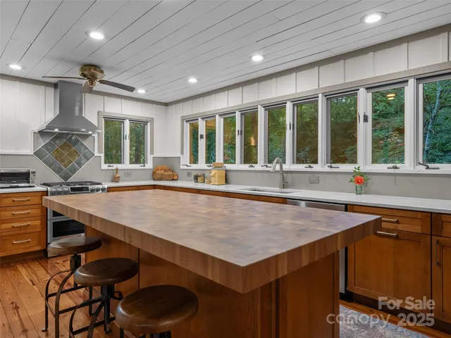 a kitchen with a table chairs sink and cabinets