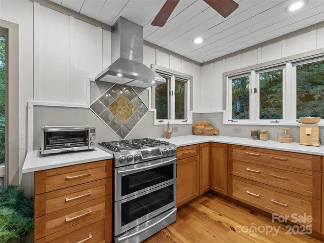 a kitchen with stainless steel appliances granite countertop a stove and a sink