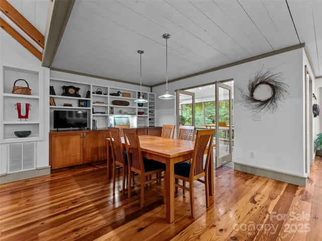 a dining room with furniture and wooden floor