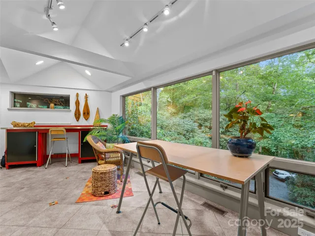 a living room with furniture and a floor to ceiling window