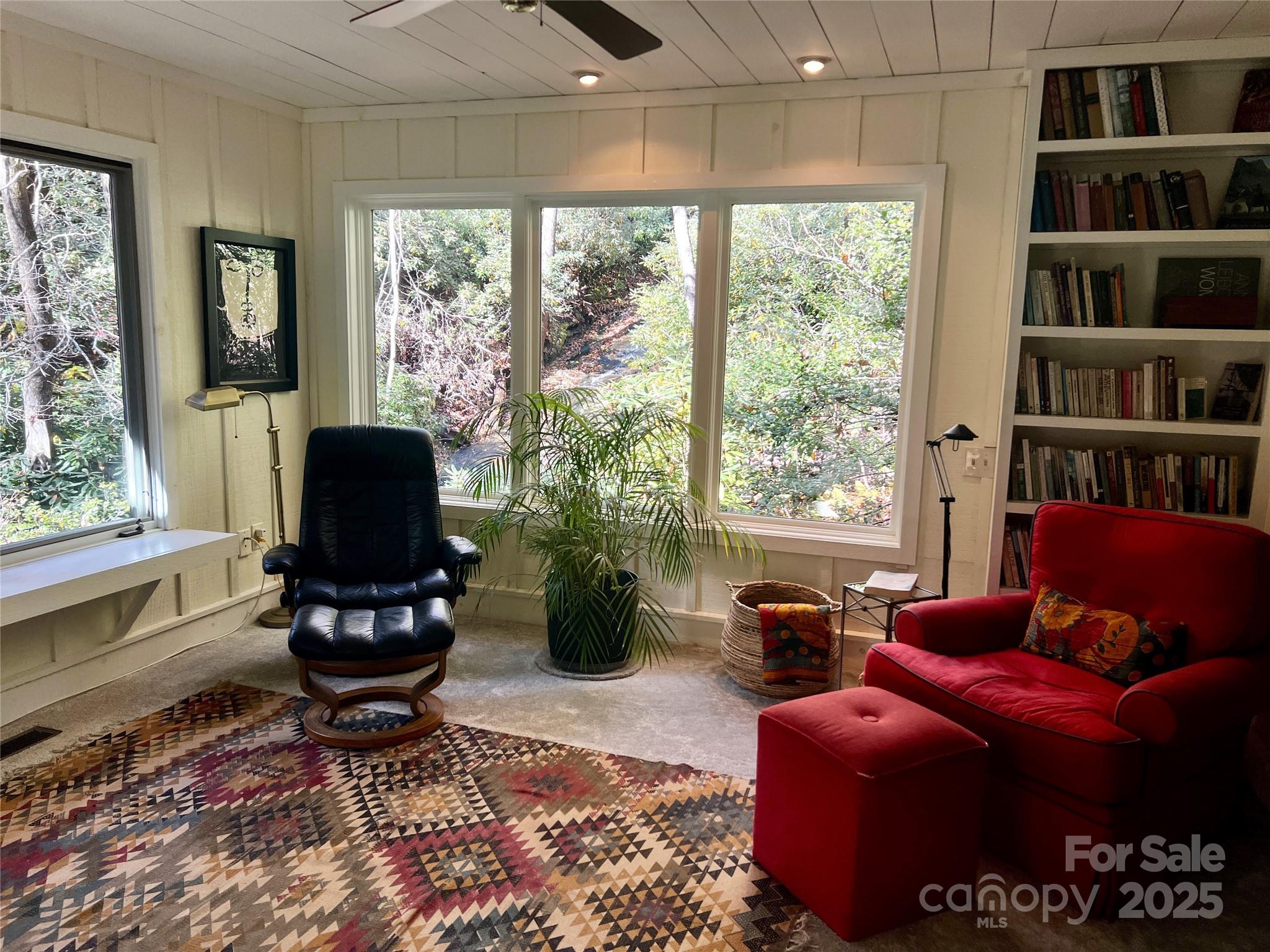 273 David's Trace Pisgah Forest, NC 28768 - Photo 22 of 48 a living room with furniture a flat screen tv and a floor to ceiling window