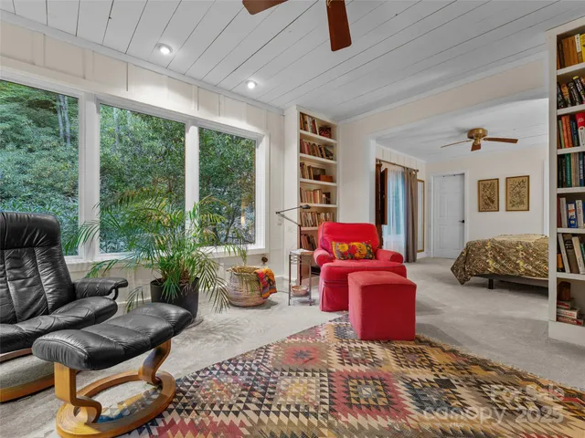 a bedroom with a bed couch and window