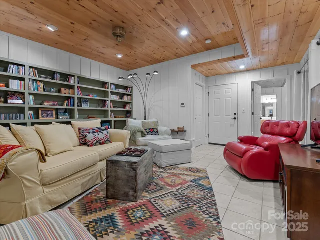 a spacious bedroom with a bed and a chandelier