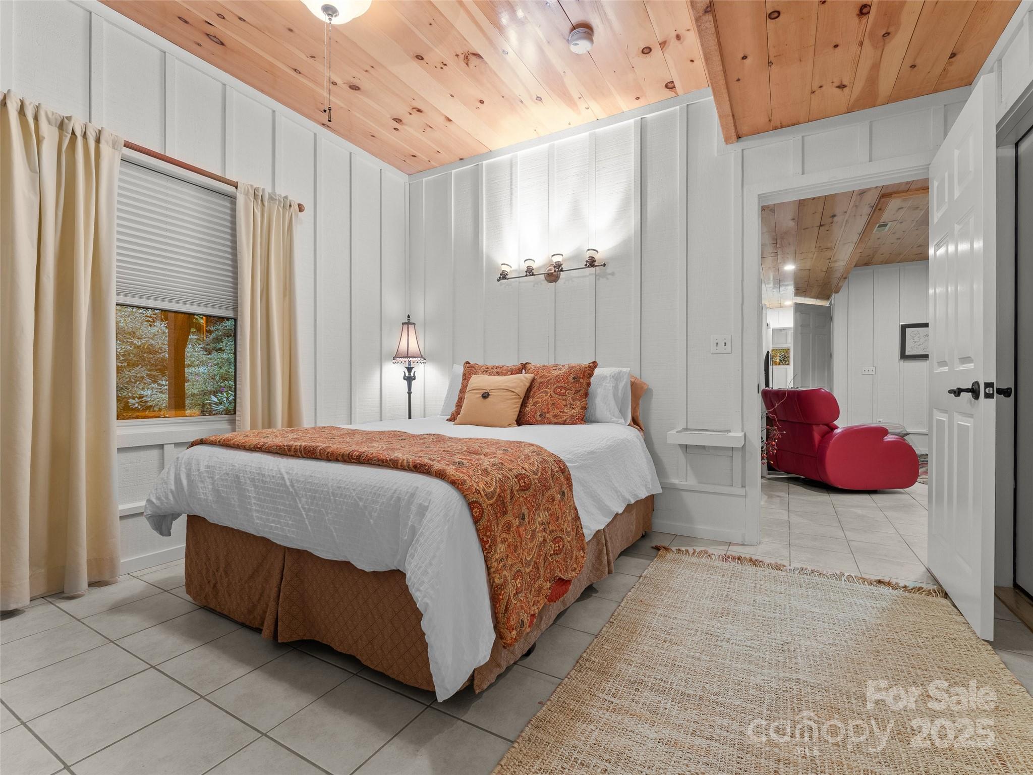 273 David's Trace Pisgah Forest, NC 28768 - Photo 36 of 48 a spacious bedroom with a bed and a chandelier