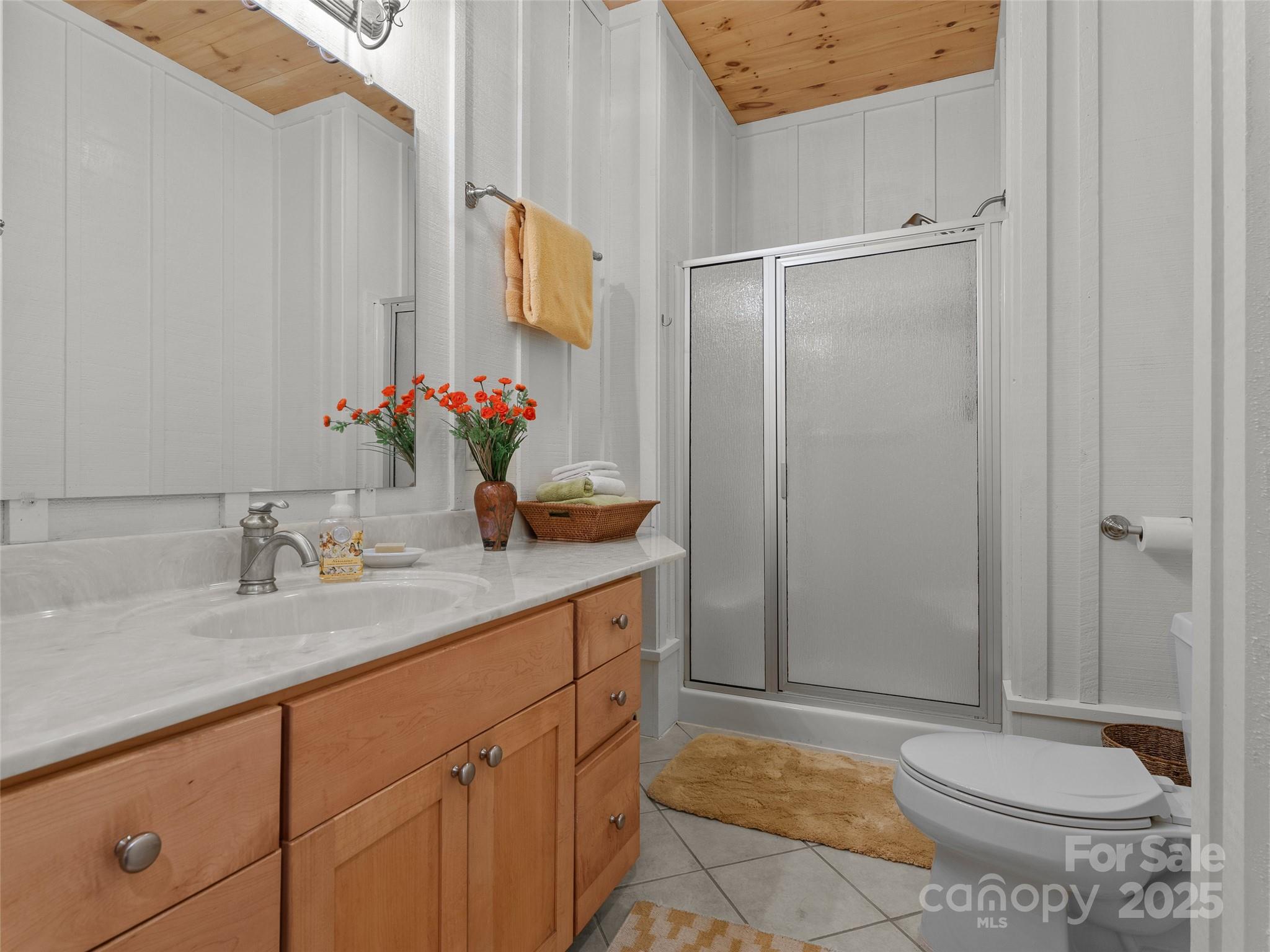 273 David's Trace Pisgah Forest, NC 28768 - Photo 40 of 48 a bathroom with a granite countertop sink and a mirror
