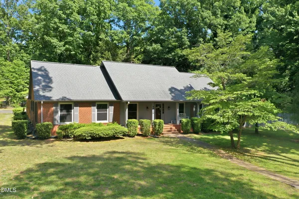 a front view of house with yard and green space