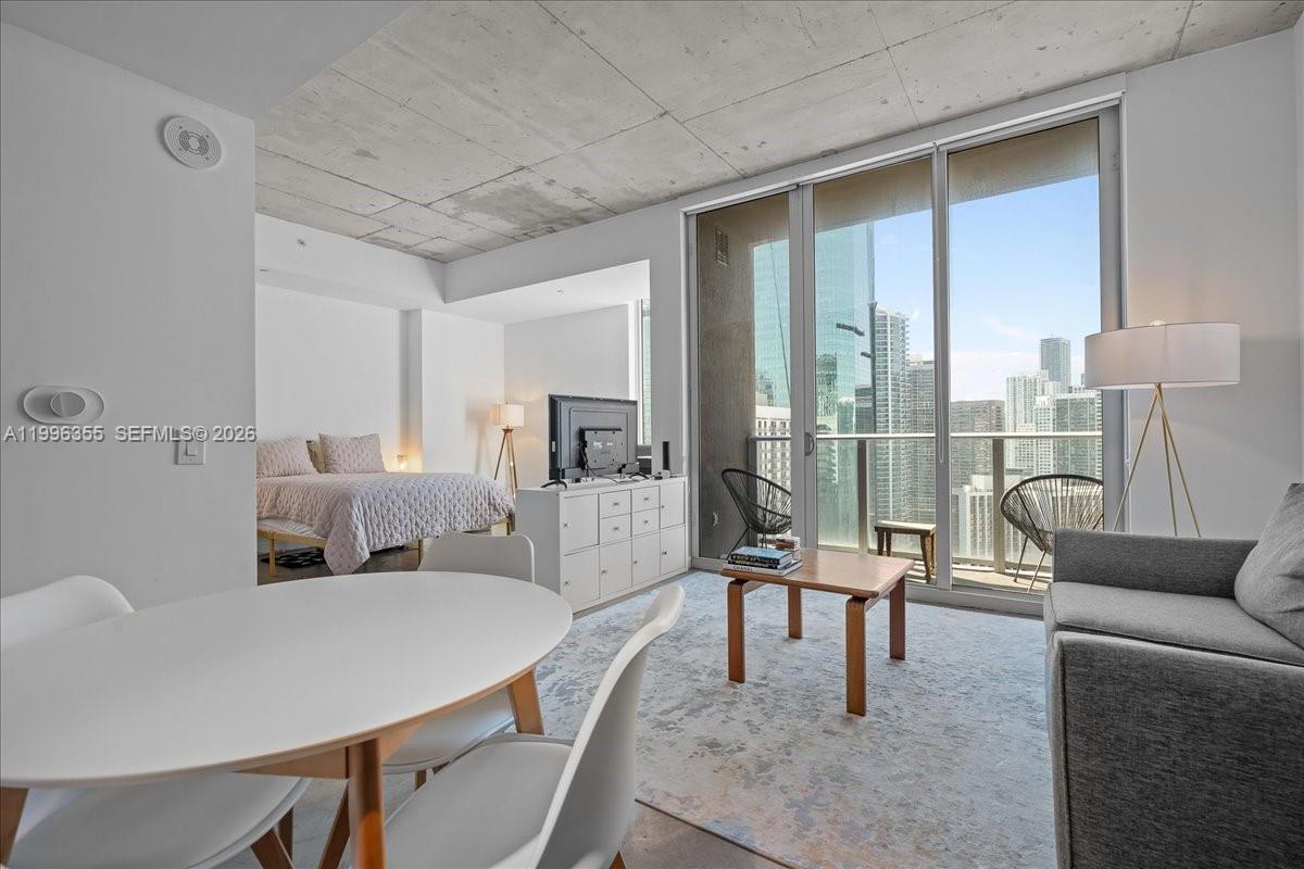 151 Southeast 1st Street, Unit 3107 Miami, FL 33131 - Photo 1 of 30 a living room with furniture and a floor to ceiling window