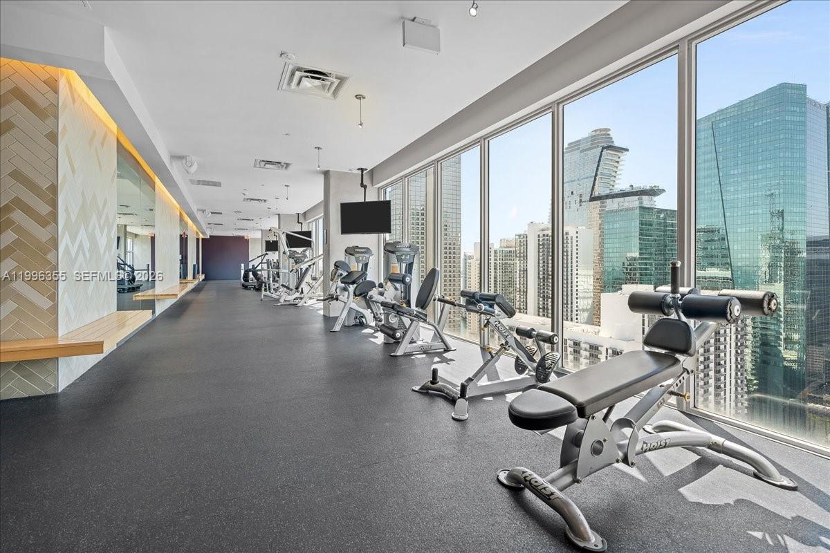151 Southeast 1st Street, Unit 3107 Miami, FL 33131 - Photo 13 of 30 a view of a room with gym equipment