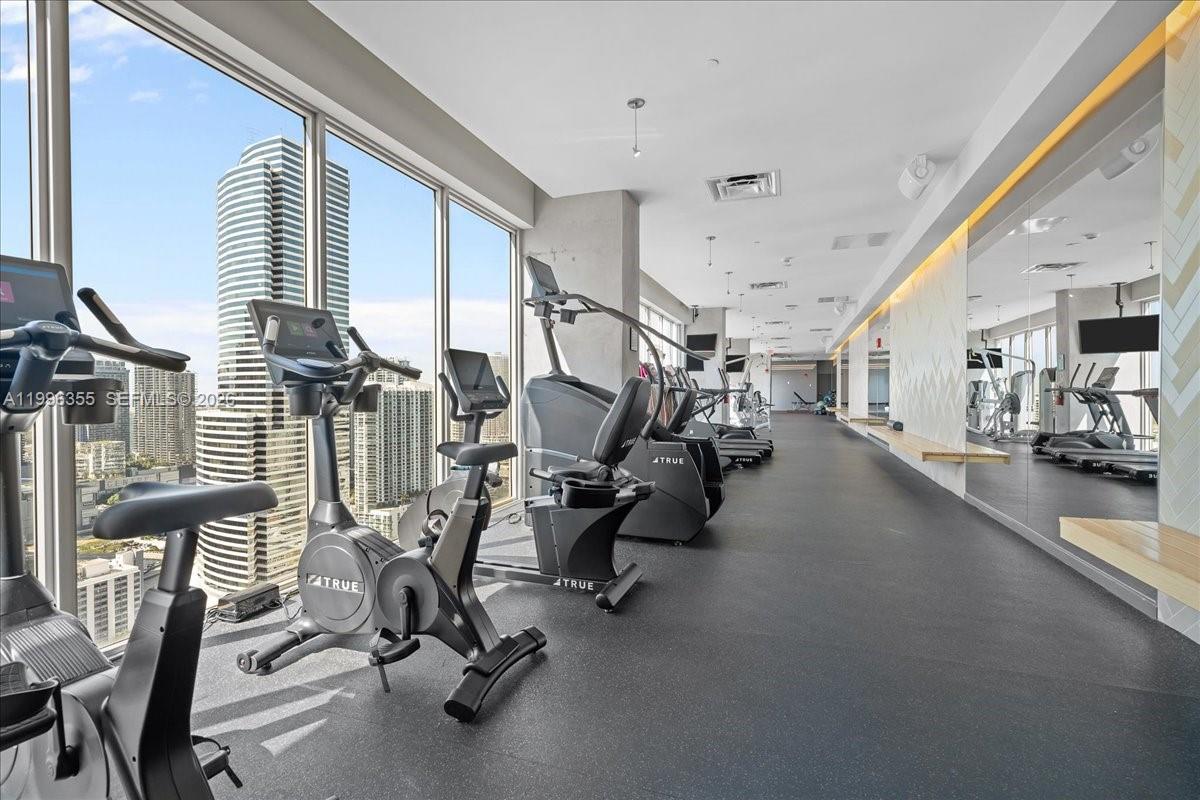 151 Southeast 1st Street, Unit 3107 Miami, FL 33131 - Photo 14 of 30 a view of a room with gym equipment