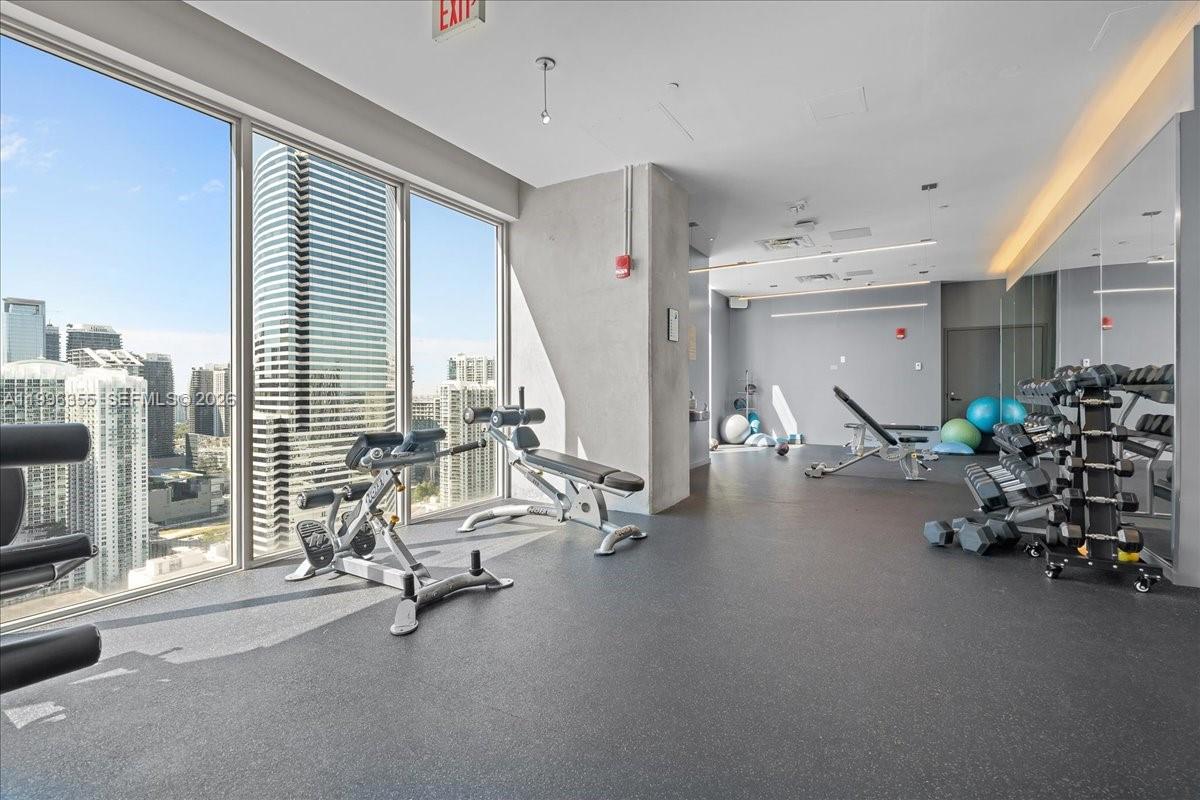 151 Southeast 1st Street, Unit 3107 Miami, FL 33131 - Photo 15 of 30 a view of a room with gym equipment