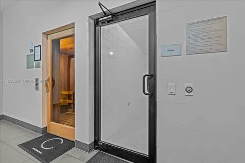 a view of a bathroom with a glass door shower