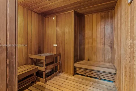 a view of a balcony with chairs and wooden floor