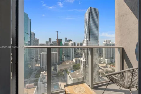 a view of a balcony with floor to ceiling windows and wooden floor