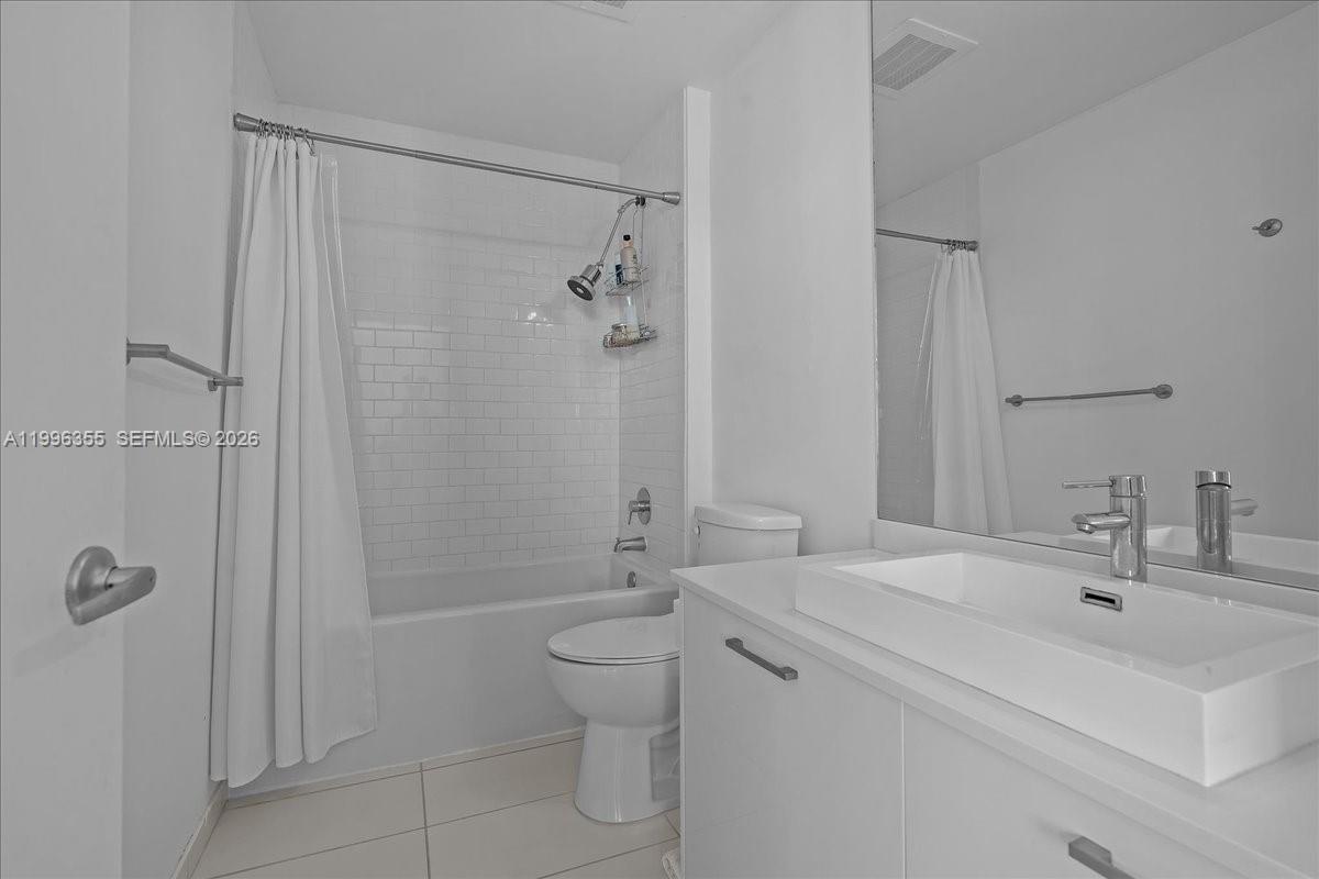 151 Southeast 1st Street, Unit 3107 Miami, FL 33131 - Photo 8 of 30 a bathroom with a sink toilet and shower