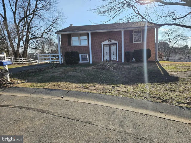 a view of a house with a yard covered with snow