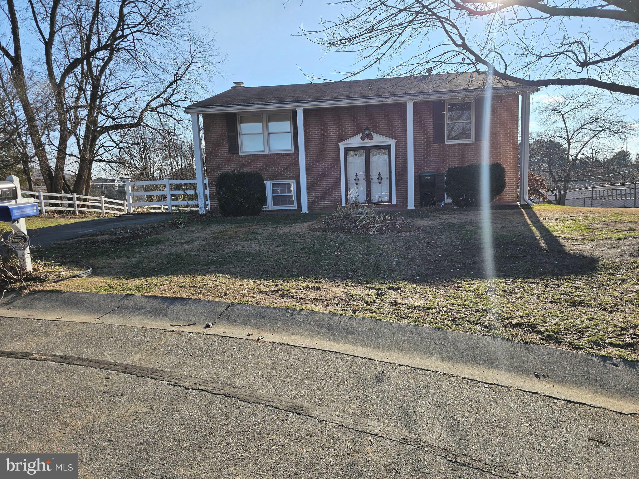 a view of a house with a yard covered with snow