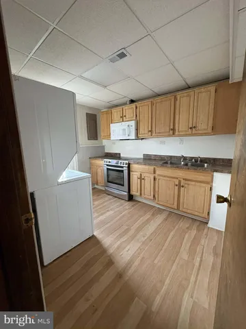 a kitchen with stainless steel appliances granite countertop a stove a sink dishwasher and a refrigerator