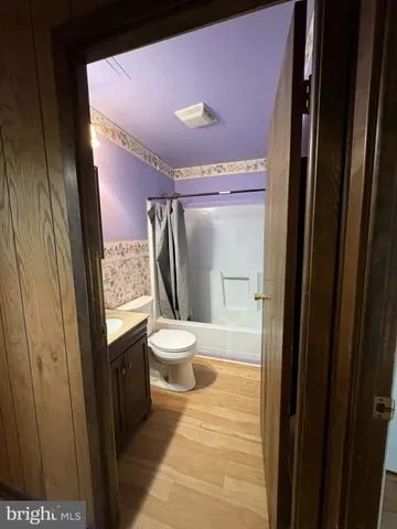 a bathroom with a sink a toilet a mirror and vanity