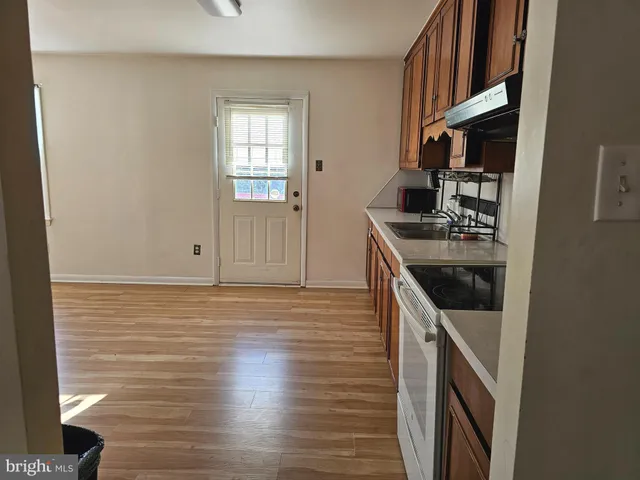 a kitchen with stainless steel appliances granite countertop a stove and a refrigerator