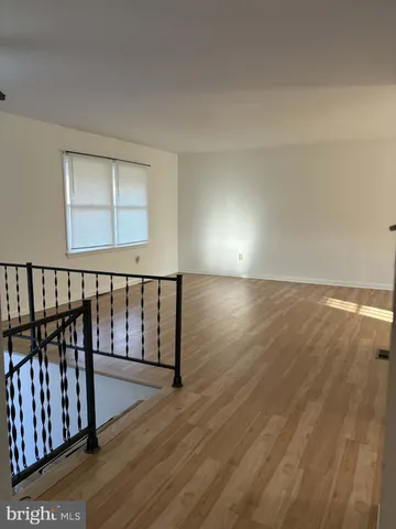 a view of hallway with wooden floor