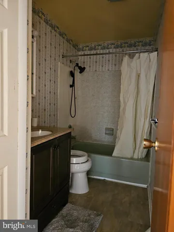 a bathroom with a shower a toilet and sink