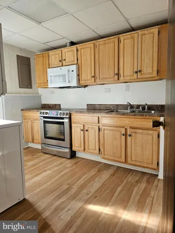 a kitchen with a stove top oven sink and cabinets