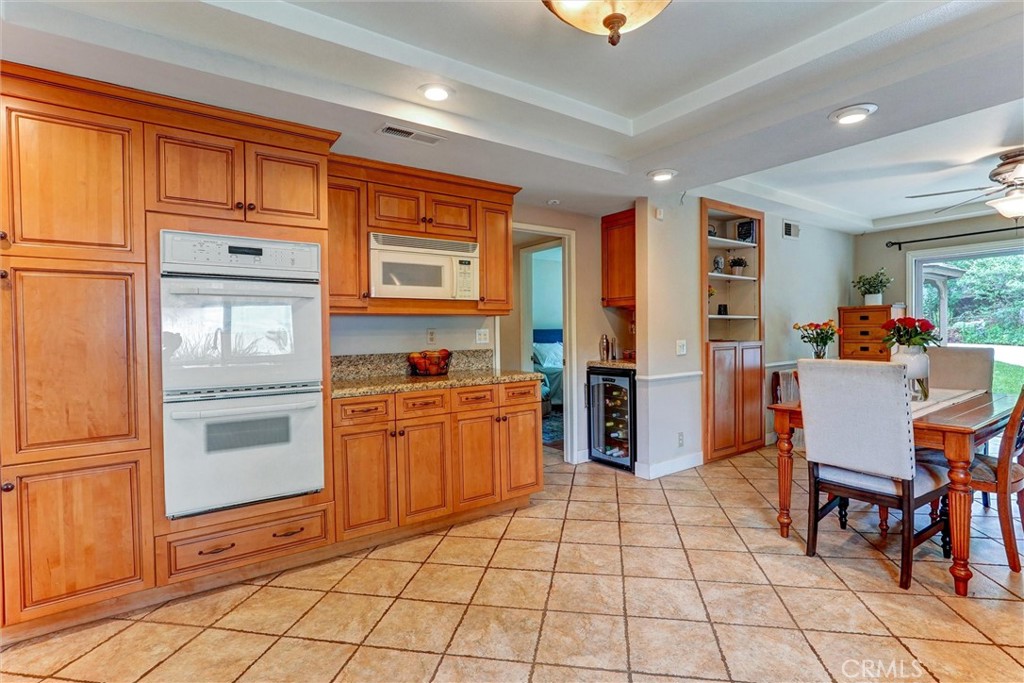 19238 Castlebay Lane Porter Ranch, CA 91326 - Photo 10 of 38 a kitchen with stainless steel appliances granite countertop a refrigerator and a stove top oven