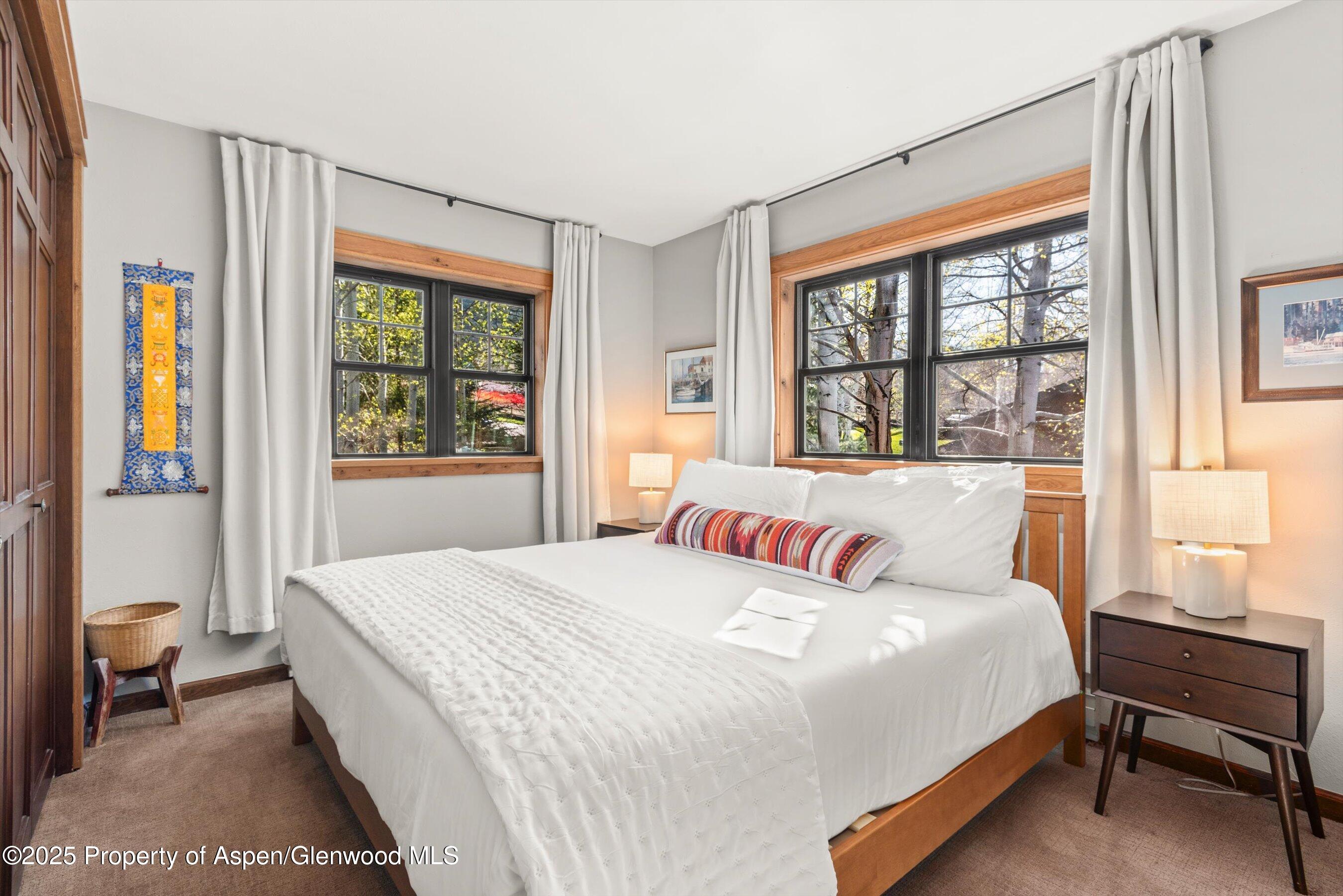 113 Crossland Drive Basalt, CO 81621 - Photo 13 of 28 a bedroom with a large bed and a window