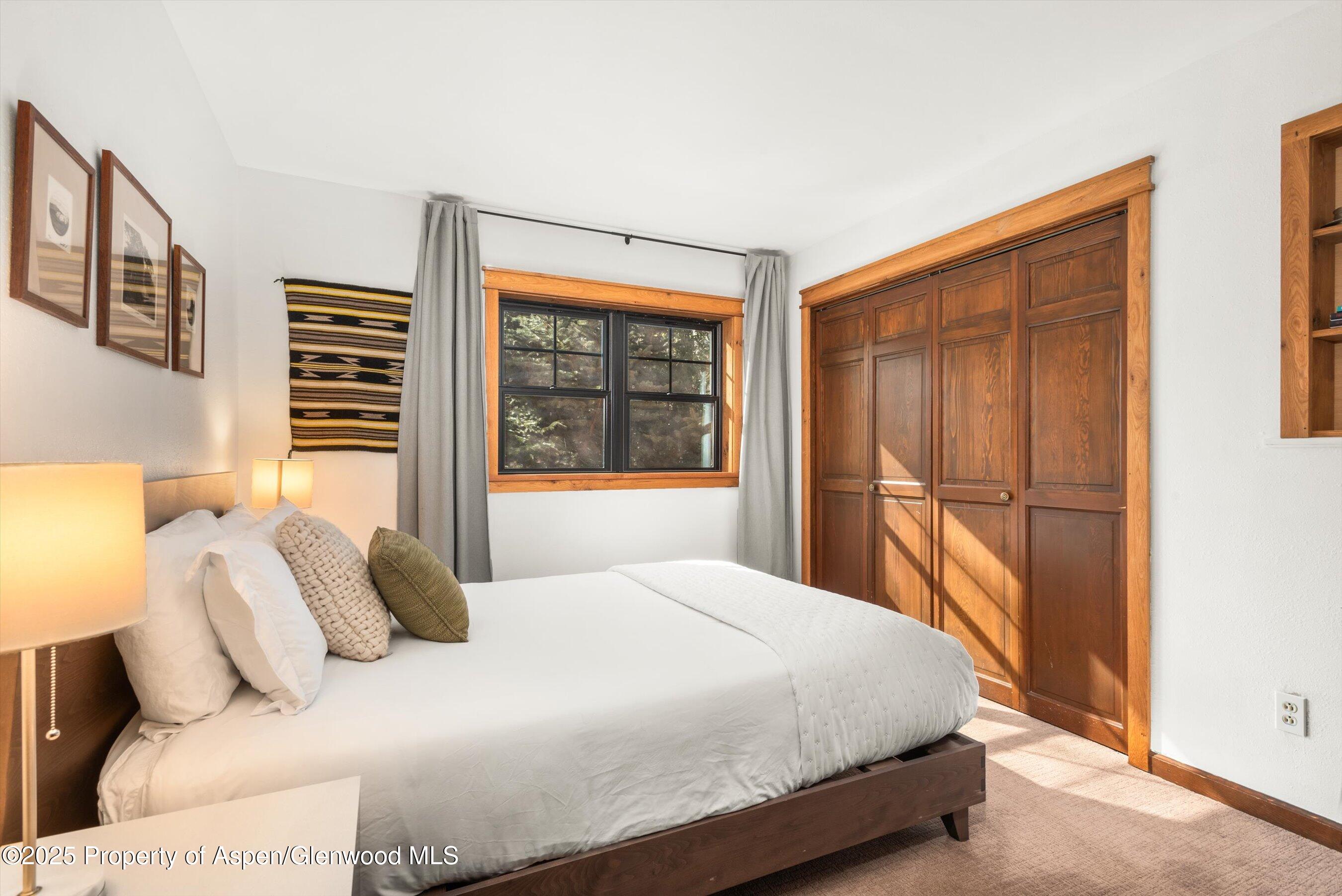 113 Crossland Drive Basalt, CO 81621 - Photo 14 of 28 a bedroom with a large bed and a window