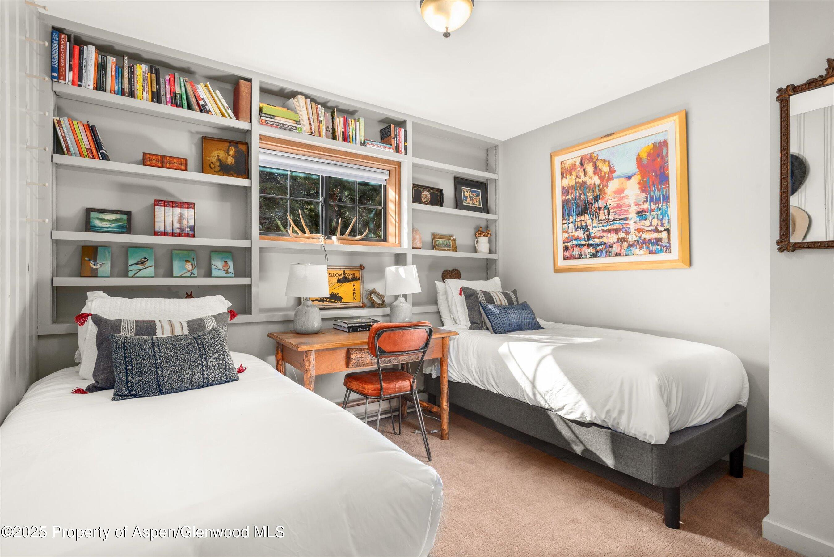 113 Crossland Drive Basalt, CO 81621 - Photo 16 of 28 a bedroom with bed and a book shelf