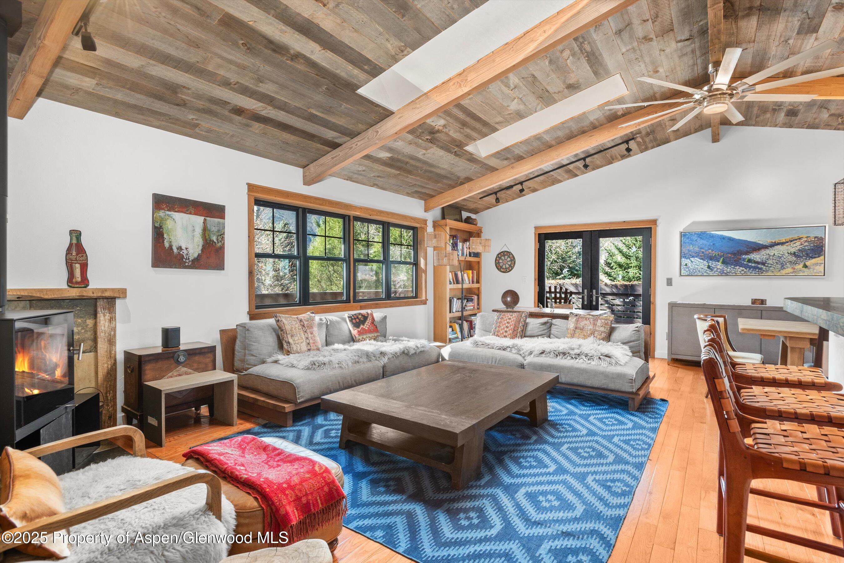 113 Crossland Drive Basalt, CO 81621 - Photo 3 of 28 a living room with furniture a rug and a flat screen tv