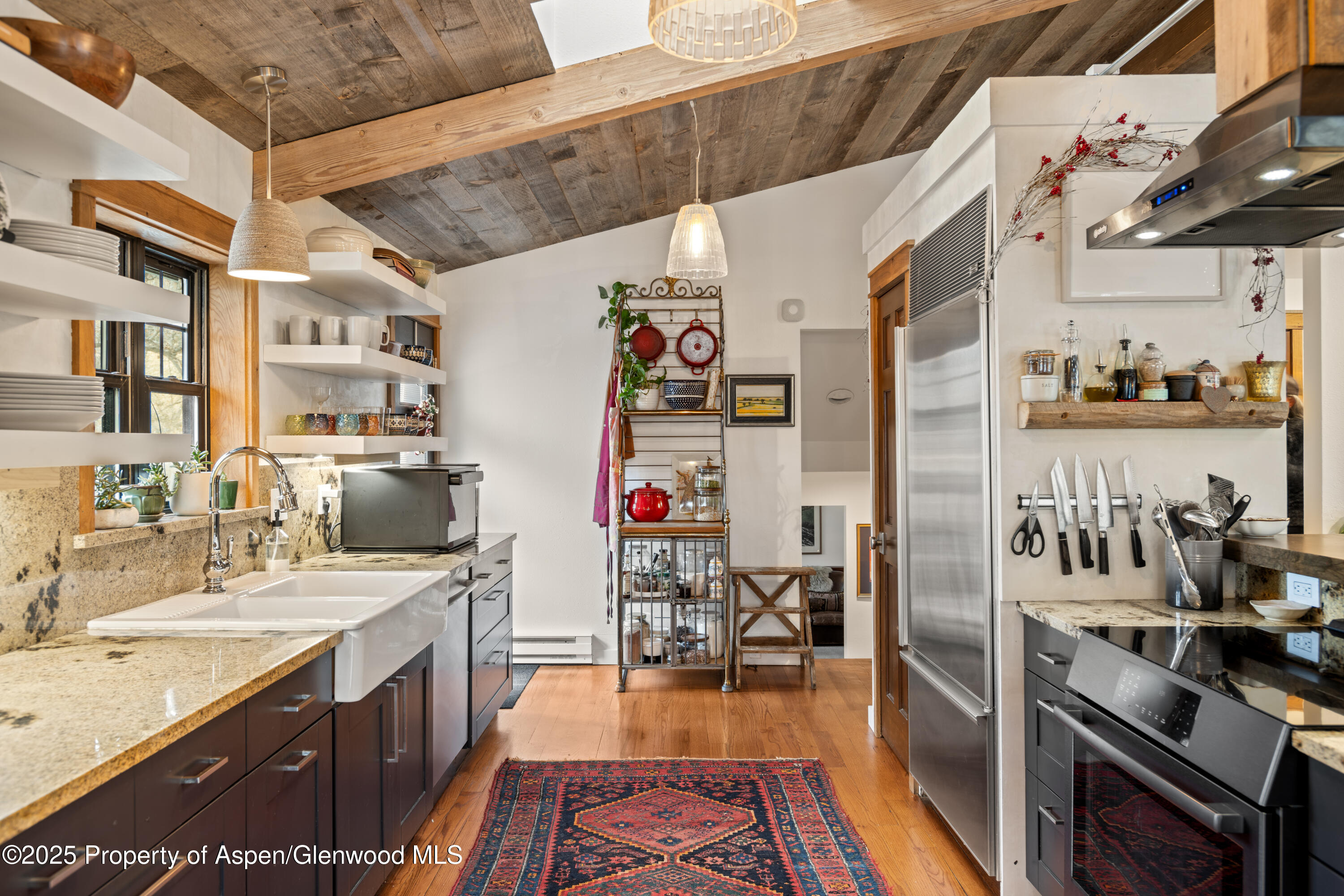 113 Crossland Drive Basalt, CO 81621 - Photo 8 of 28 a kitchen with stainless steel appliances granite countertop a sink stove and refrigerator