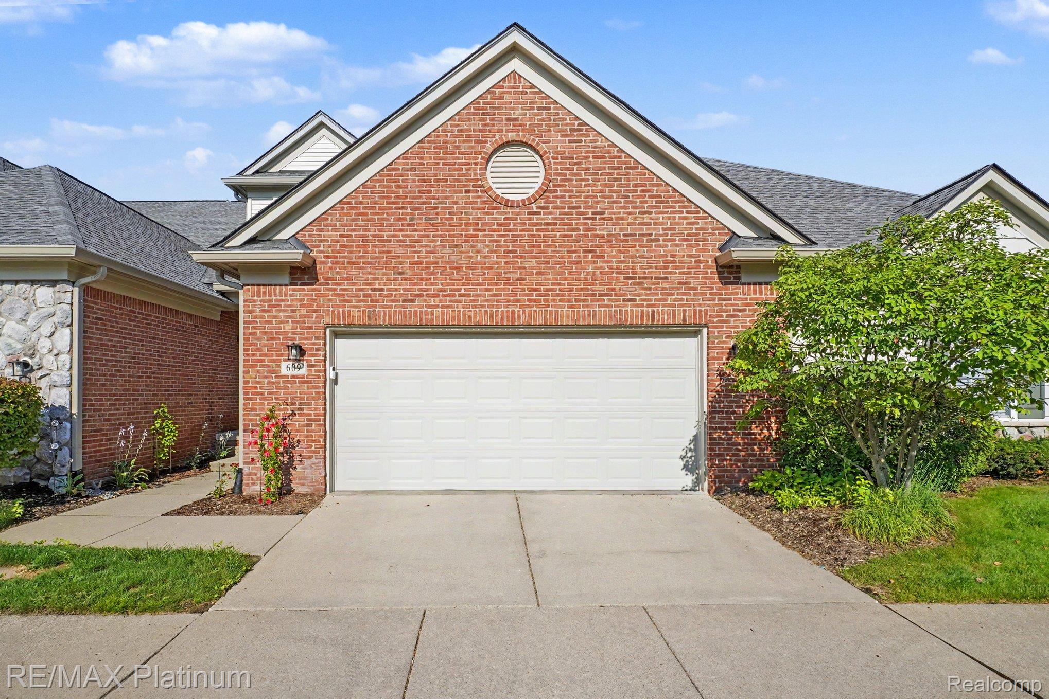 609 Telya Ridge Milford, MI 48381 - Photo 3 of 28 Brick exterior with a peaked gable roofline and a circular vent feature