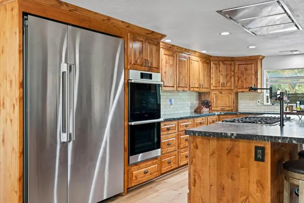a living room with furniture a chandelier and a flat screen tv