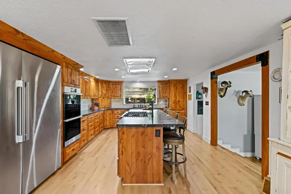 a kitchen with a sink stove and cabinets