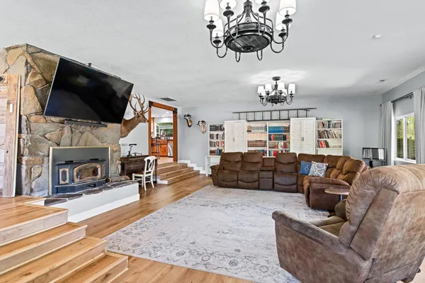 a bedroom with a bed dresser and wooden floor