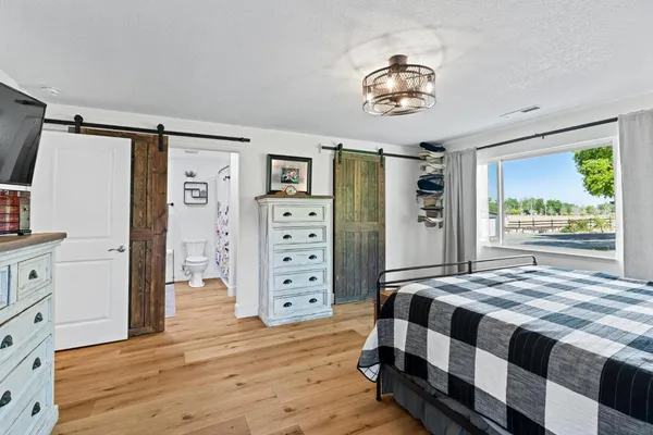 a living room with furniture and a floor to ceiling window