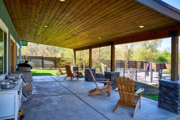 a view of swimming pool with sitting area and furniture