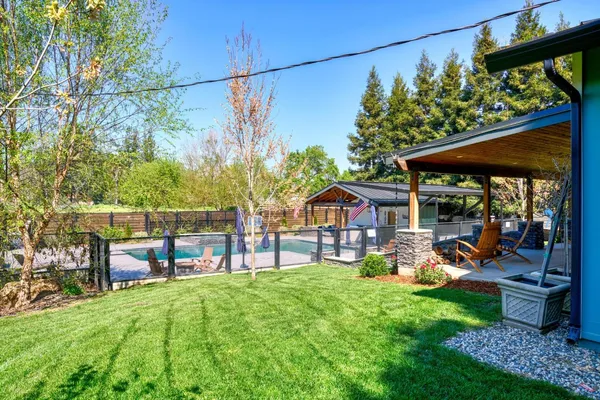 a backyard of a house with yard and outdoor seating