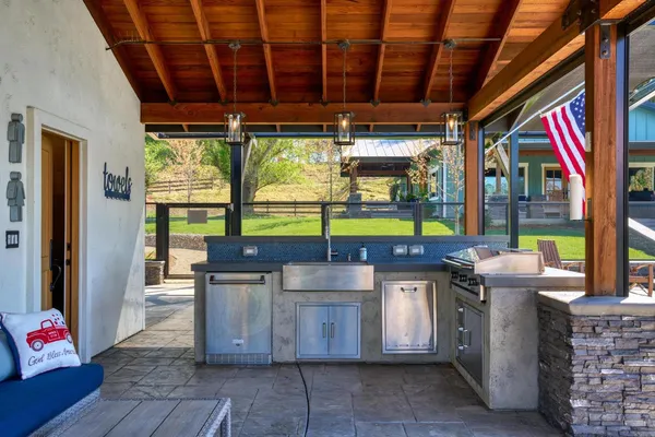 a view of outdoor space with seating area and trees in the background
