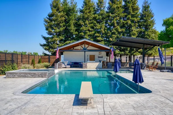 a view of a house with a yard and tree s