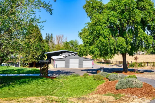 a view of a house with a yard balcony and furniture